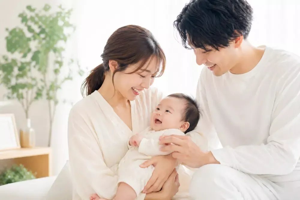 笑顔の赤ちゃんと両親の家族写真